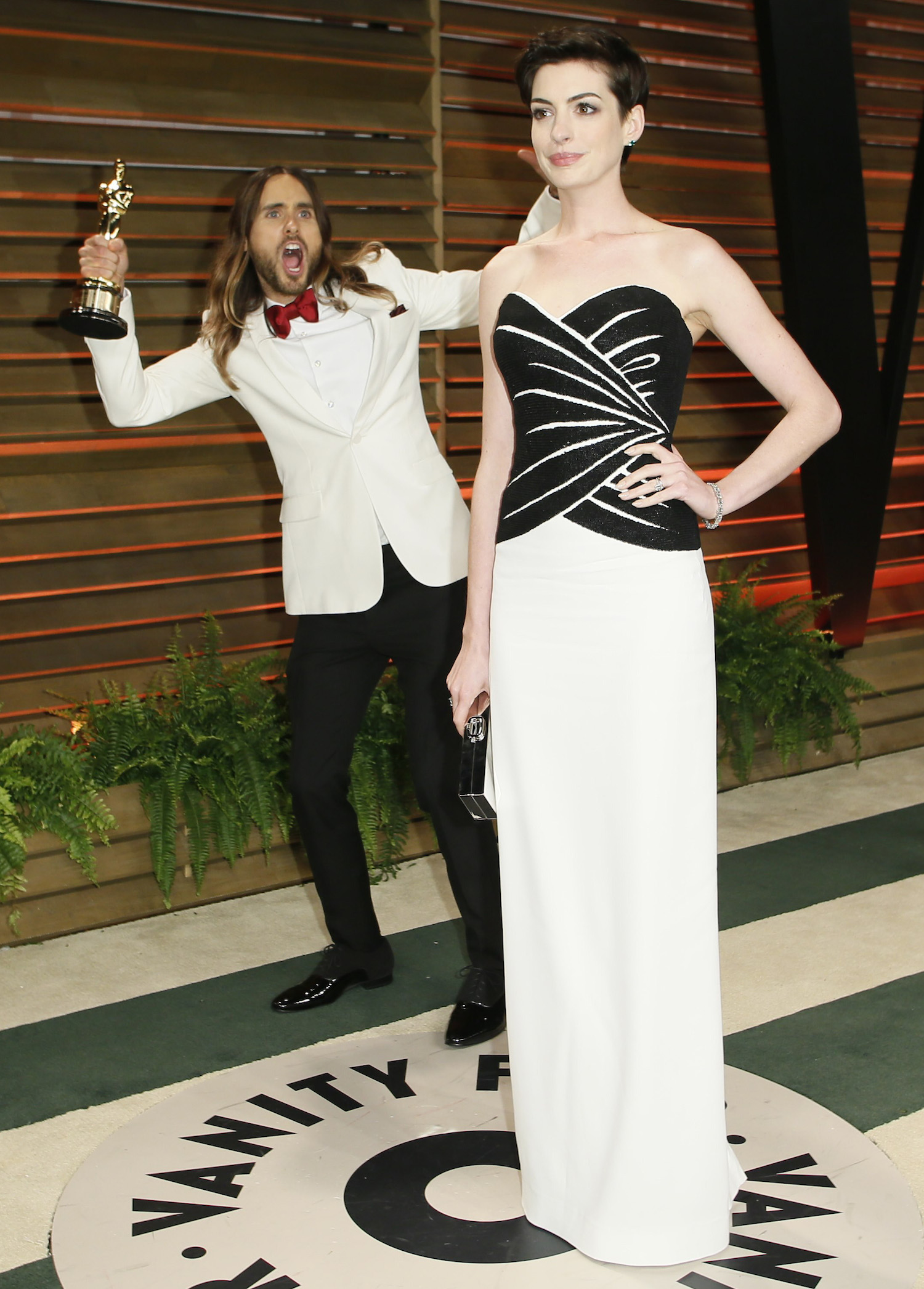 Leto jokes around as actress Anne Hathaway poses as they arrive at the 2014 Vanity Fair Oscars Party in West Hollywood